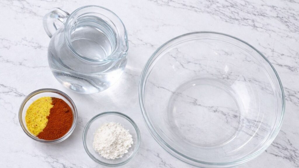 Ingredients for the cooking liquid for sarma, including water, cornstarch, sweet paprika, salt, and spices prepared for traditional stuffed sour cabbage rolls