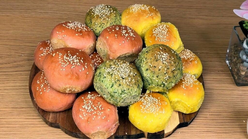 fresh baked natural colored burger buns on wooden boardn