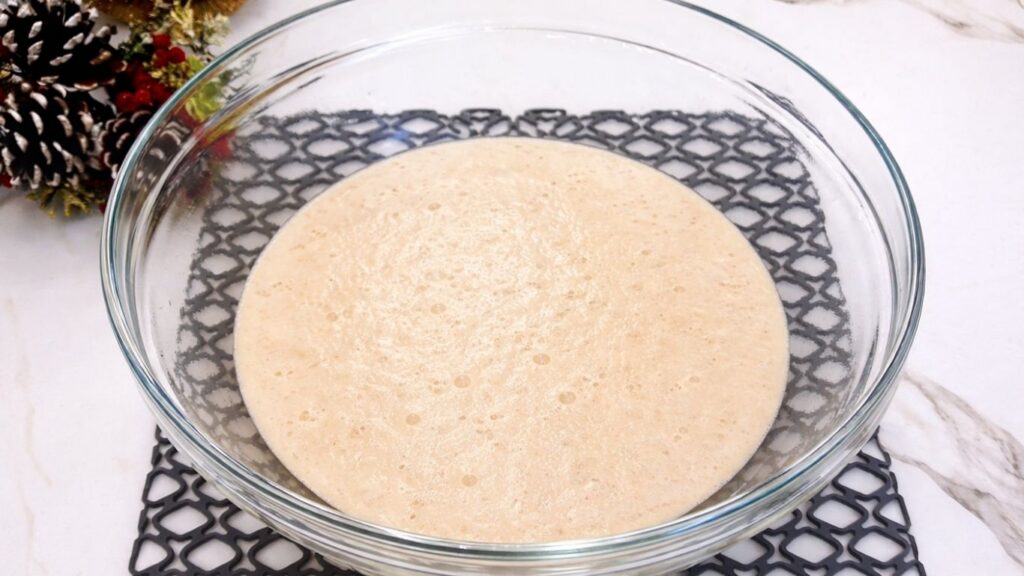 activated yeast in a glass bowl for soft homemade dinner rolls
