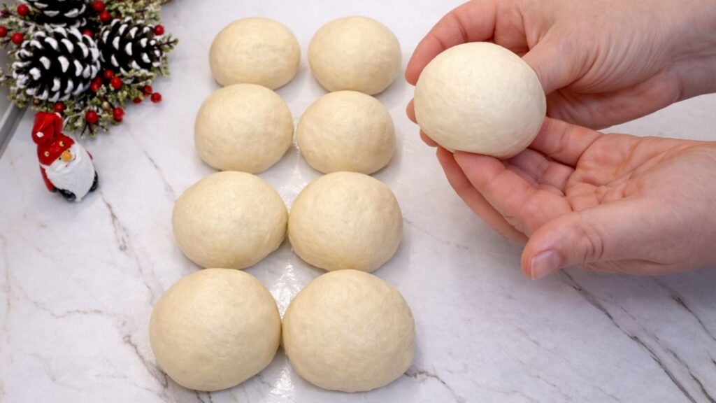 shaped dough balls ready for second rise for homemade dinner rolls