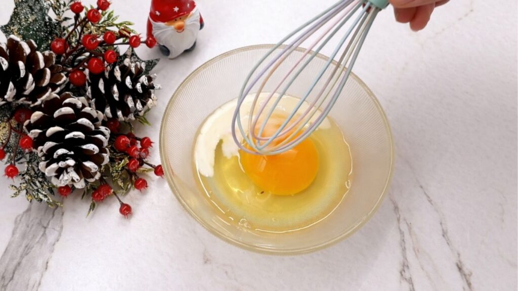 egg and milk mixture in a bowl for brushing homemade dinner rolls