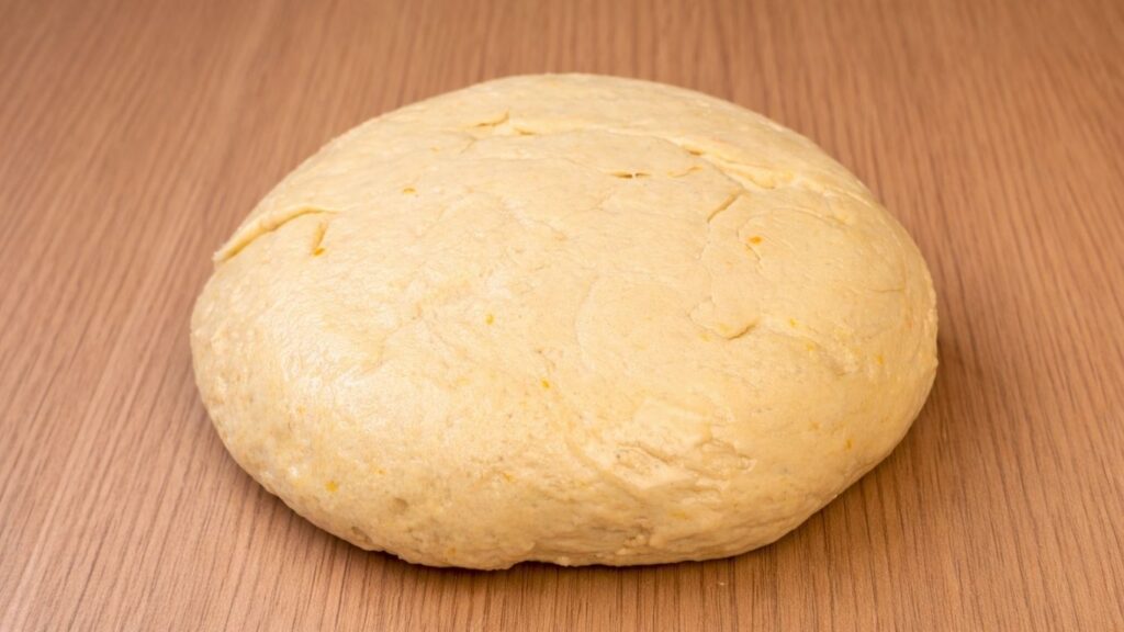 dough placed on a floured work surface ready to roll out for blueberry lemon rolls