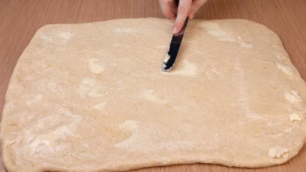 rolled dough spread with a thin layer of butter for blueberry lemon rolls