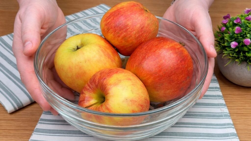 Fresh apples in a bowl prepared for making the apple cinnamon roll filling.