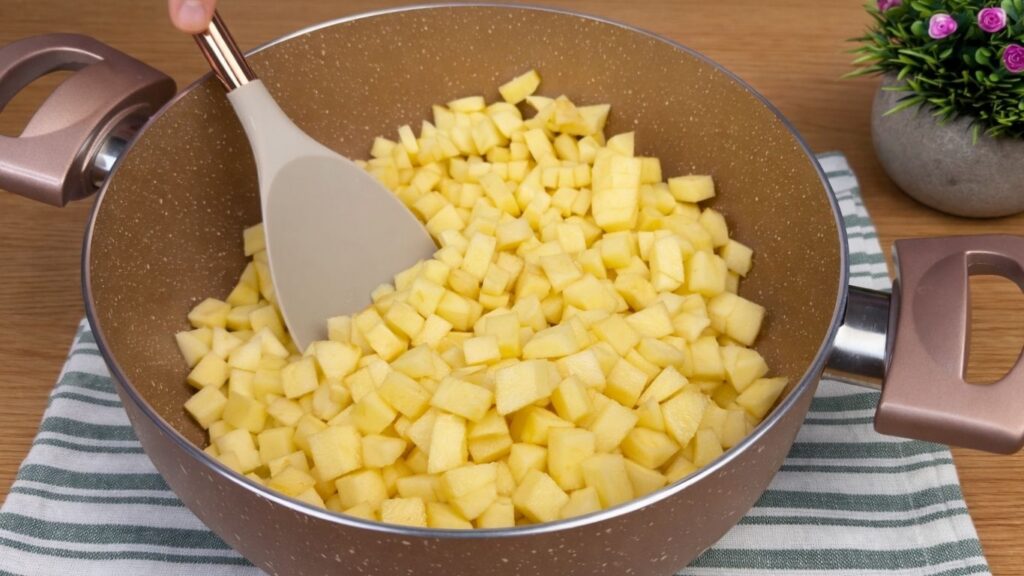 Diced apples in a saucepan ready to cook for the apple cinnamon roll filling.