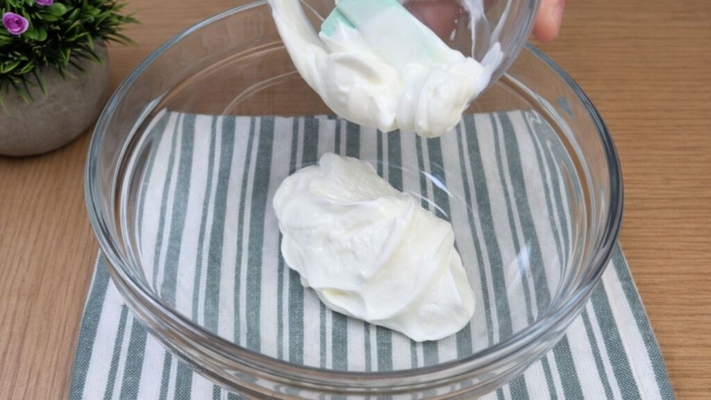 Cream cheese in a bowl prepared for making the cream cheese glaze for apple cinnamon rolls.
