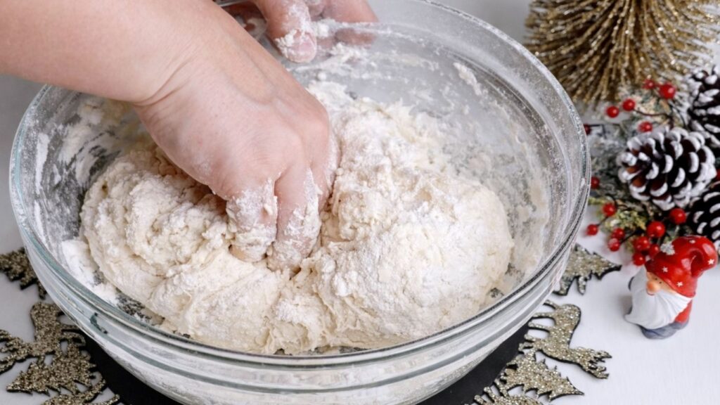 Kneading baguette dough by hand in a bowl