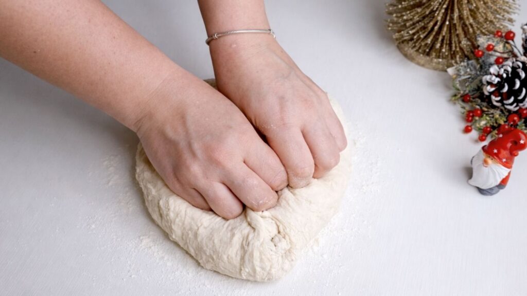 Kneading dough for homemade baguettes on kitchen counter