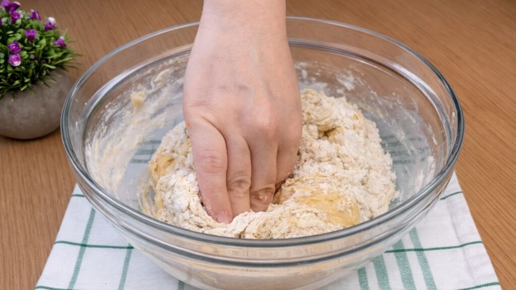 kneading the dough by hand to create a soft and smooth dough for blueberry lemon rolls