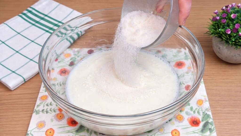 adding sugar to warm milk for homemade cinnamon rolls dough