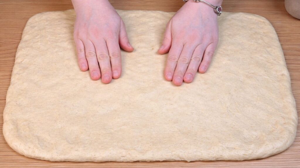 rolled out dough ready for filling for homemade cinnamon rolls
