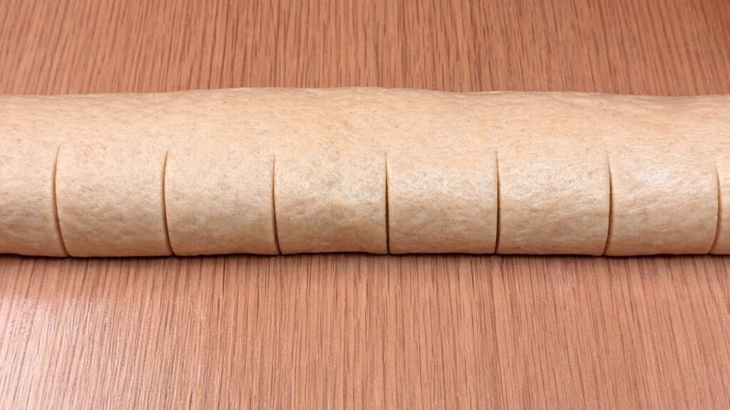 marked dough ready to be cut into homemade cinnamon rolls