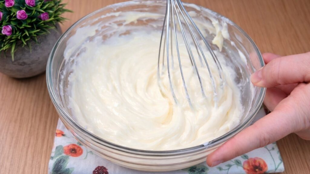 smooth and creamy whipped cream cheese glaze ready for homemade cinnamon rolls