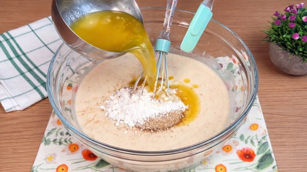 adding butter, sugar and vanilla to yeast mixture for homemade cinnamon rolls dough