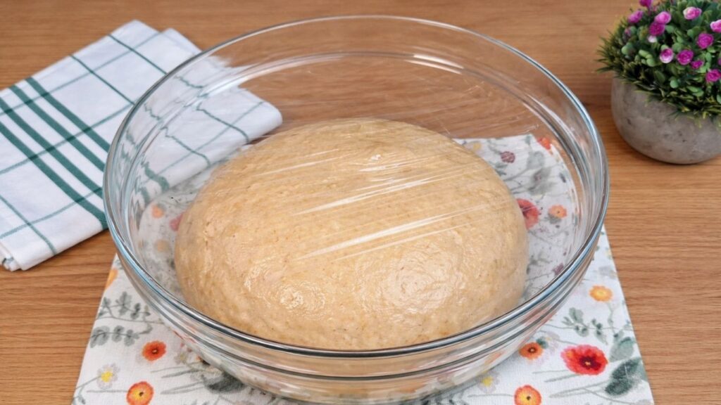 dough covered and resting until doubled in size for homemade cinnamon rolls