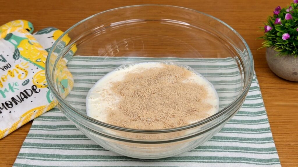 adding yeast to warm milk for lemon poppy seed rolls