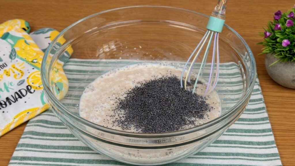 adding poppy seeds to milk mixture for lemon rolls