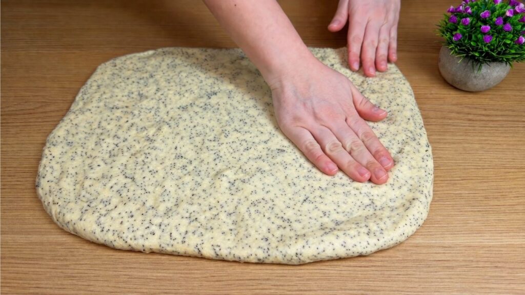 stretching dough by hand for sweet rolls