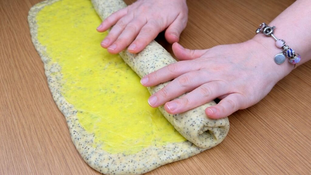 rolling lemon poppy seed roll dough