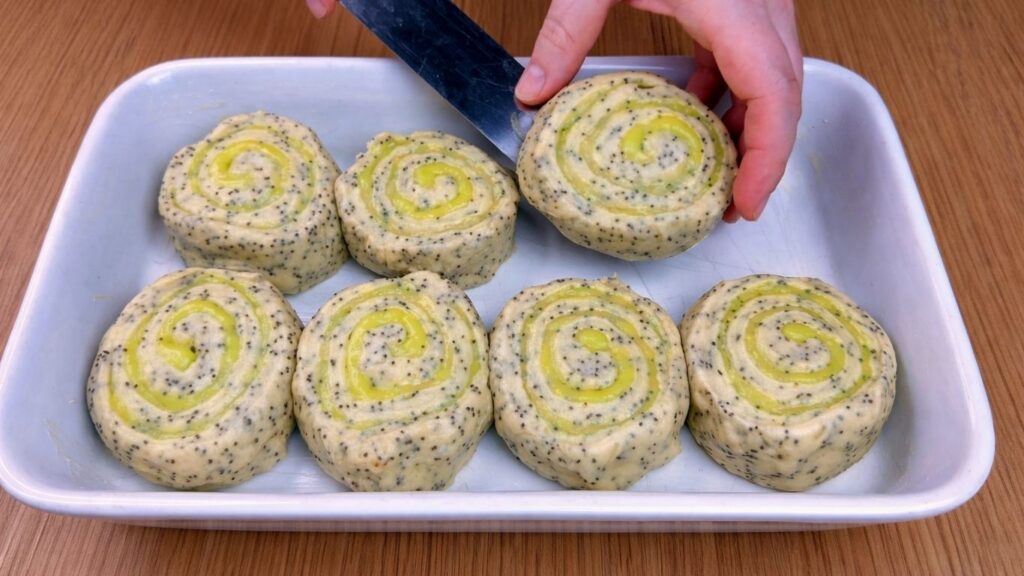 arranging rolls in baking dish before baking