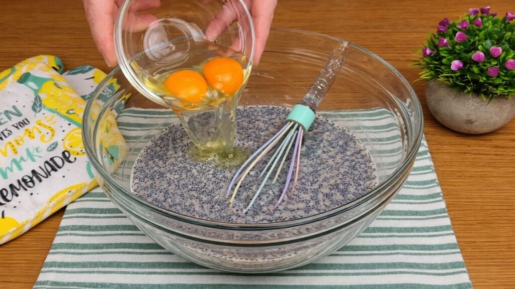 adding eggs to poppy seed mixture for dough