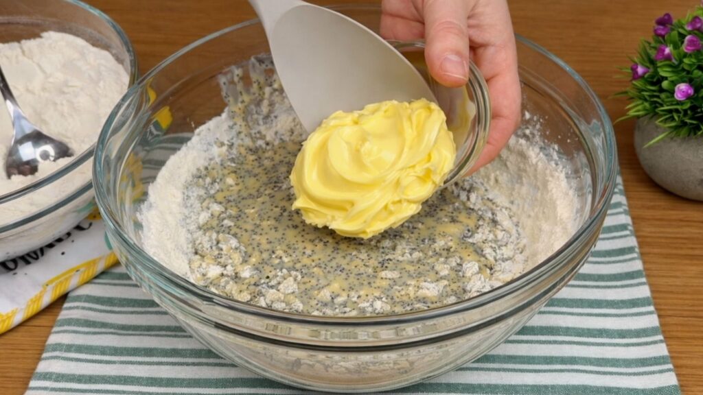 adding butter to dough mixture