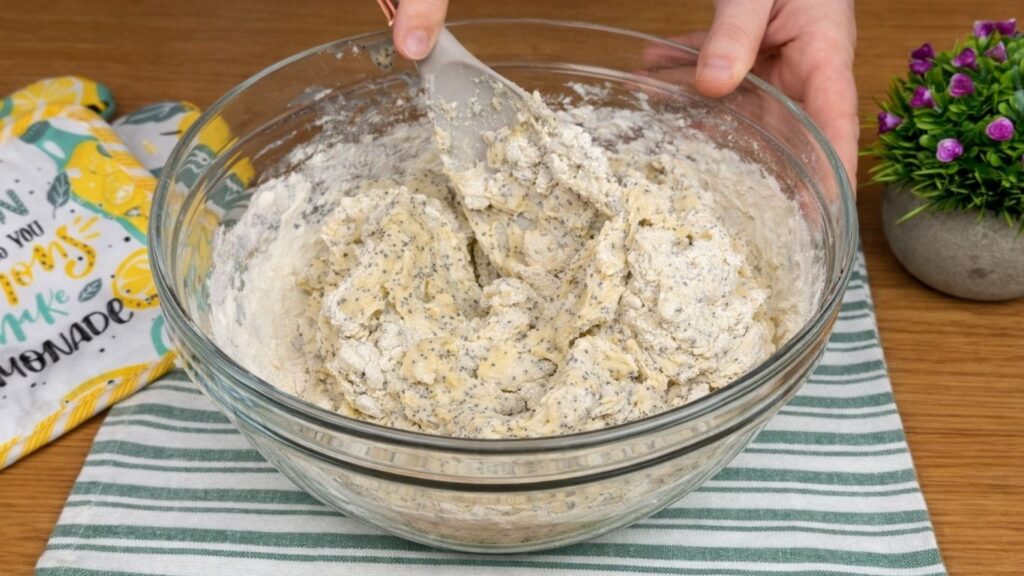 kneading dough in bowl for lemon poppy seed rolls