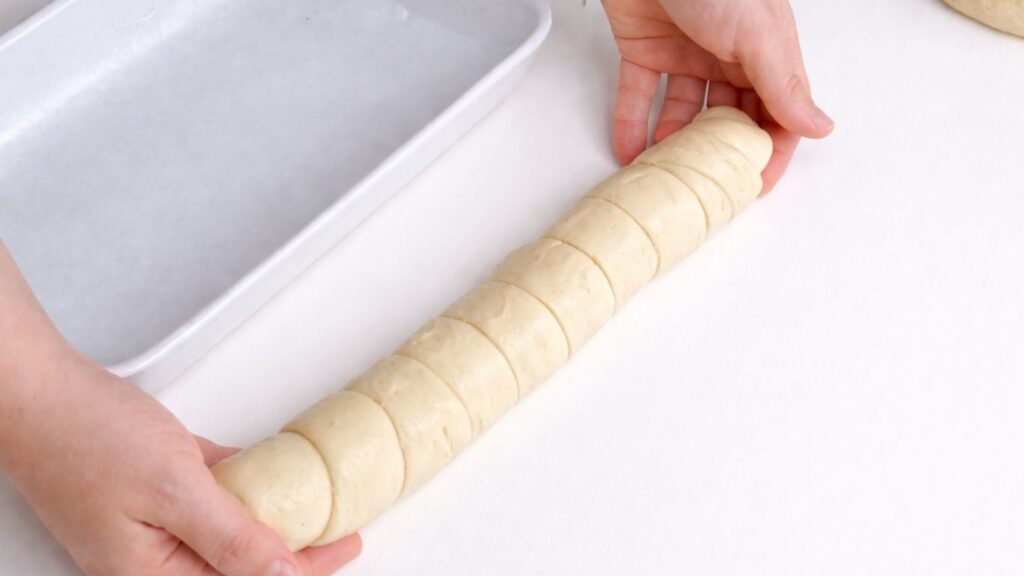 rolling dough into a loaf shape for milk bread