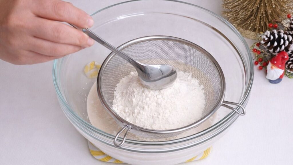 adding flour to yeast mixture for milk bread dough
