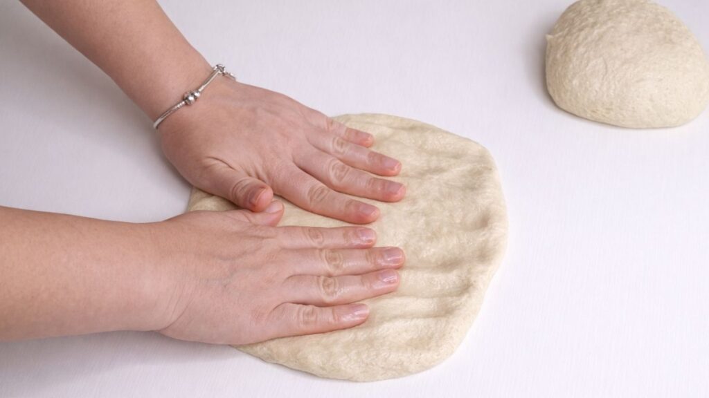 shaping dough for milk bread loaf