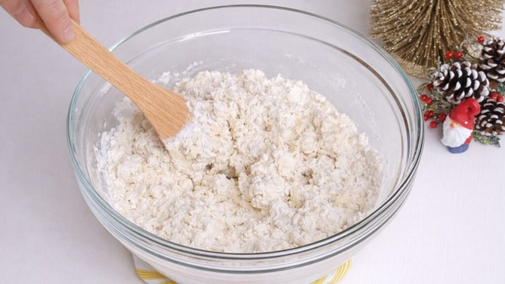 mixing milk bread dough in a bowl