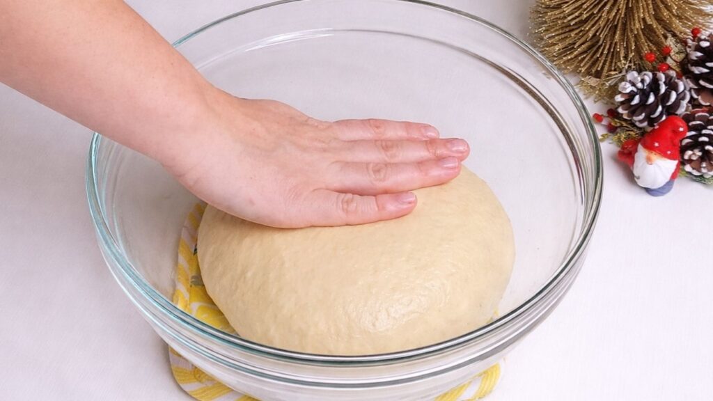 oiling milk bread dough in a bowl before the first rise