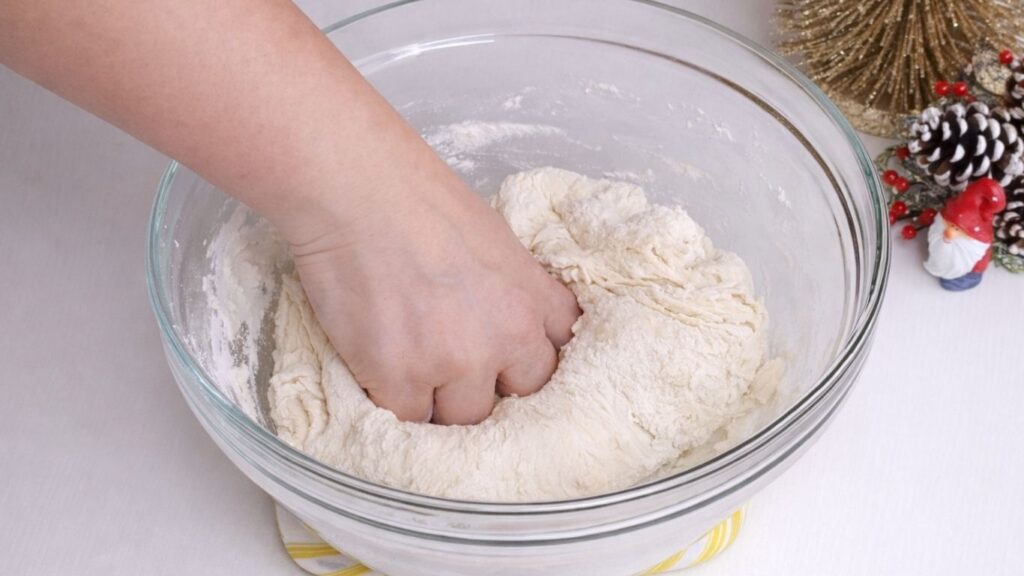 mixing milk bread dough in a bowl