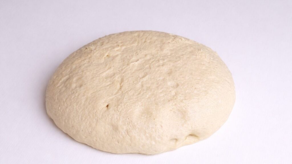 milk bread dough placed on a clean work surface