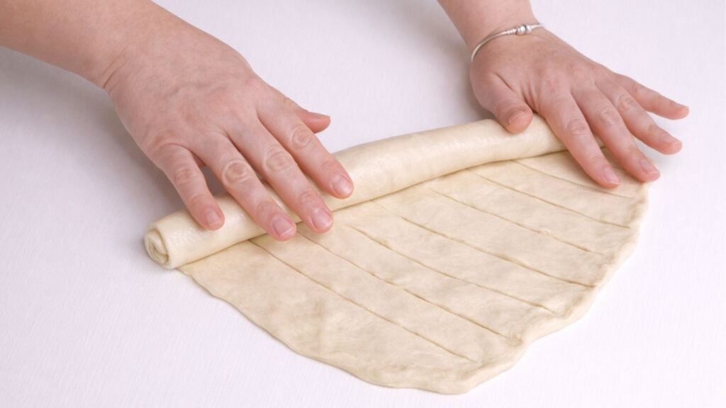 rolling dough into a loaf shape for milk bread