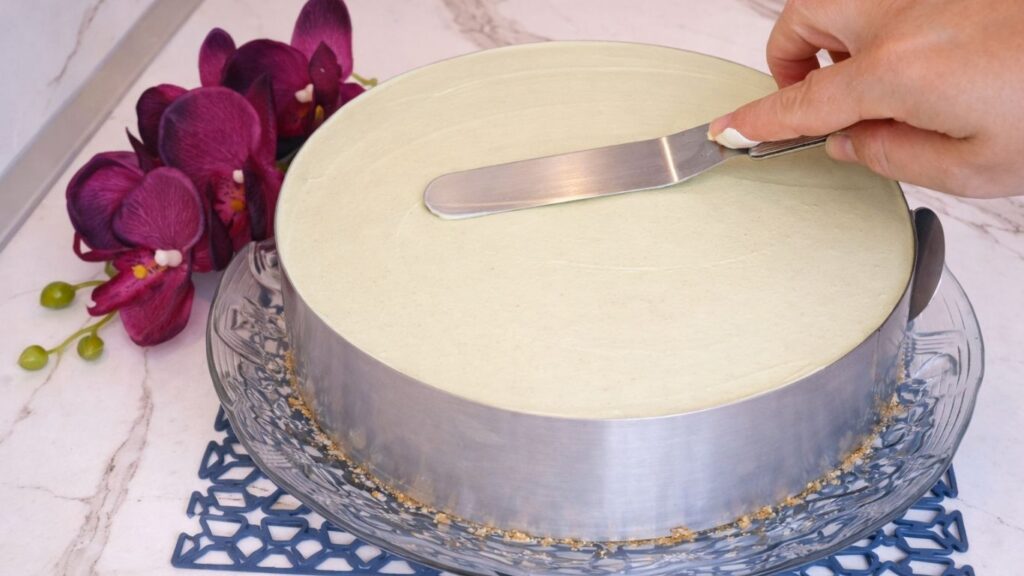 Smoothed pistachio cream layer in cake pan for no bake pistachio cake