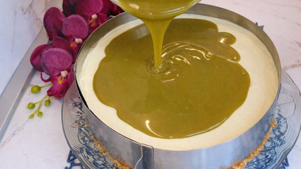 Pouring pistachio ganache over no bake pistachio cake