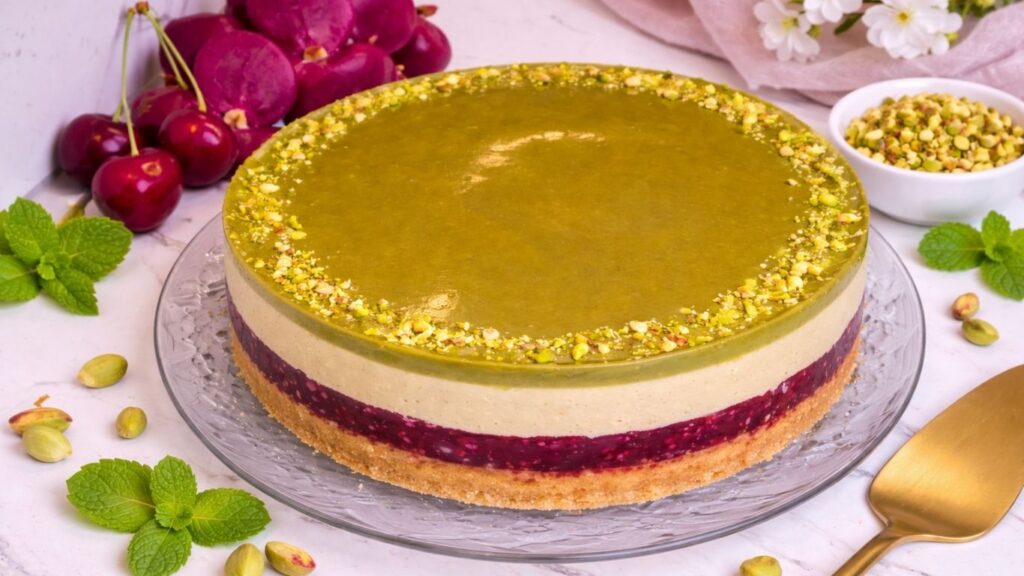 Chilled no bake pistachio cake on glass cake stand ready to serve