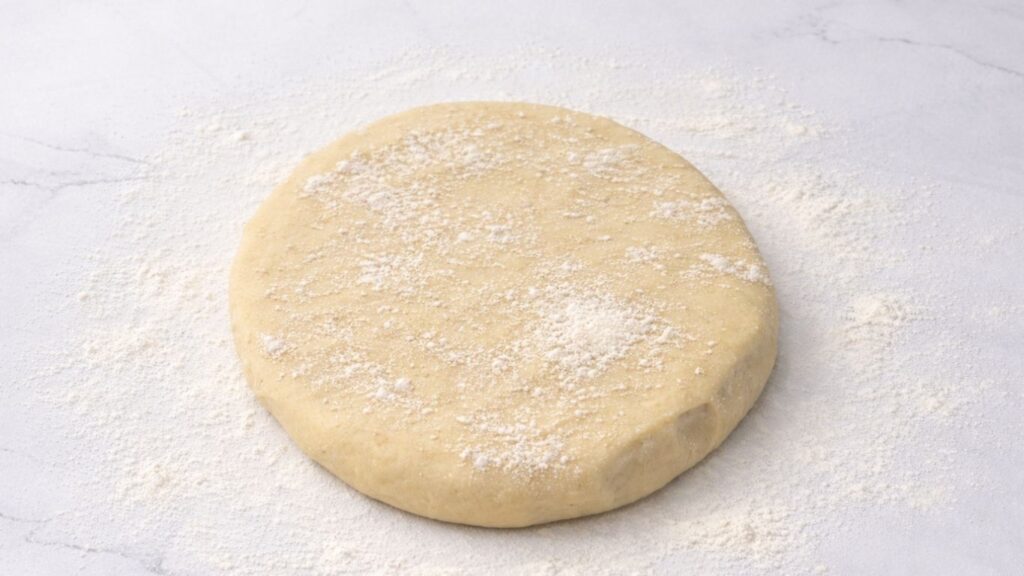 potato borek dough on a floured table ready for stretching