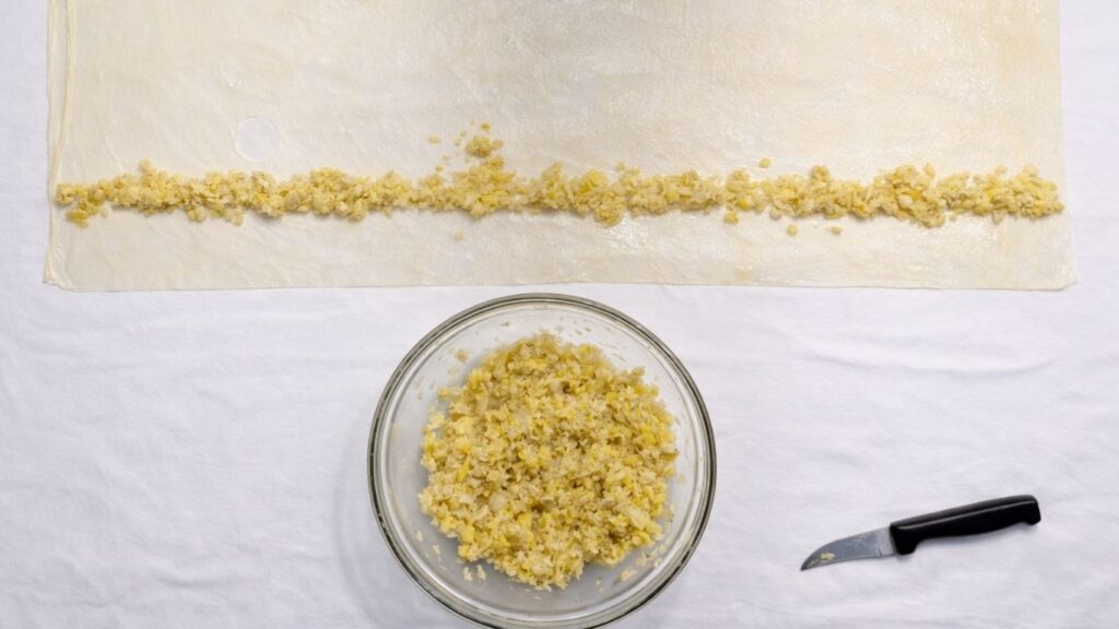 potato filling and stretched dough on the table ready for the next potato borek roll
