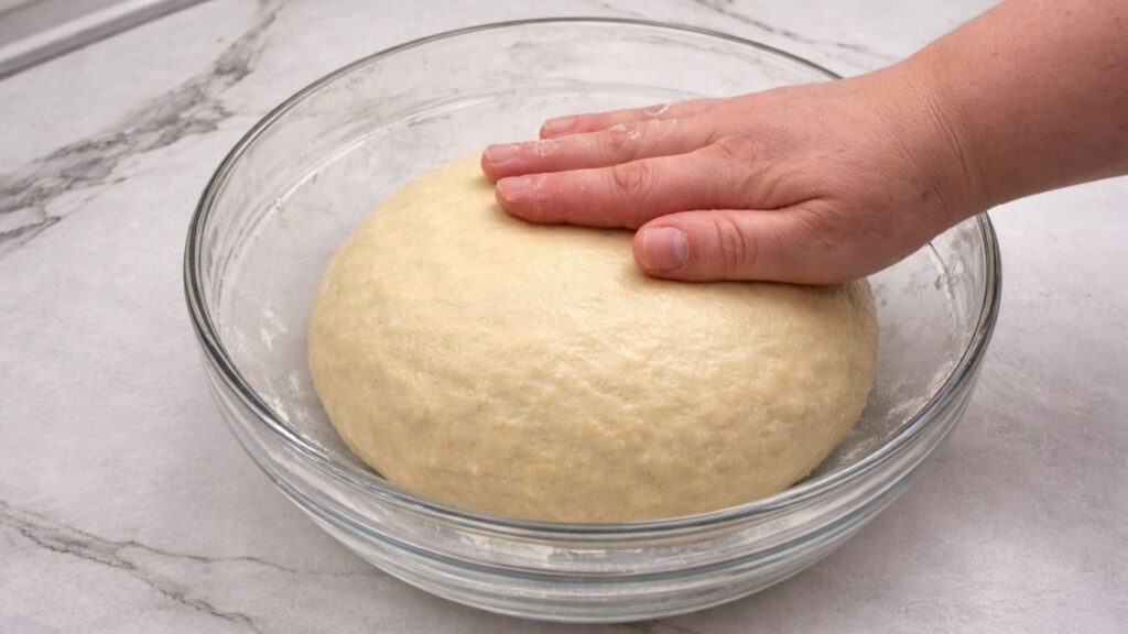 kneaded potato borek dough resting in an oiled bowl before stretching