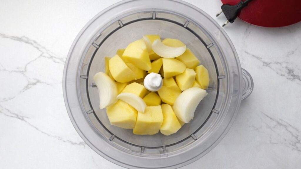 potatoes and onion in a food processor for potato borek filling