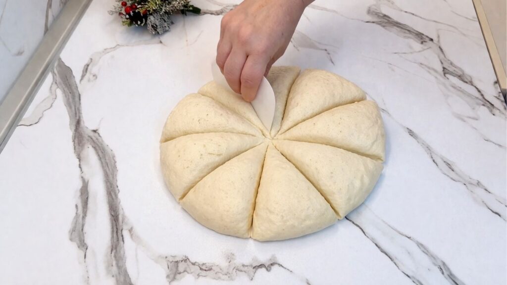 Homemade pretzel dough divided into 8 equal pieces on a work surface.