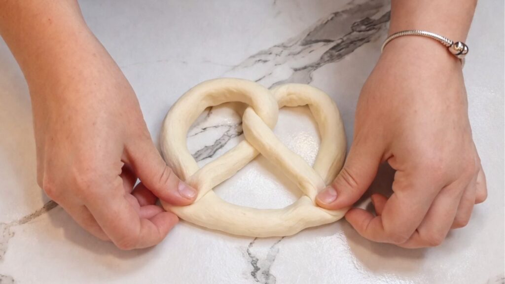 Shaped homemade pretzel ready for the baking soda bath.