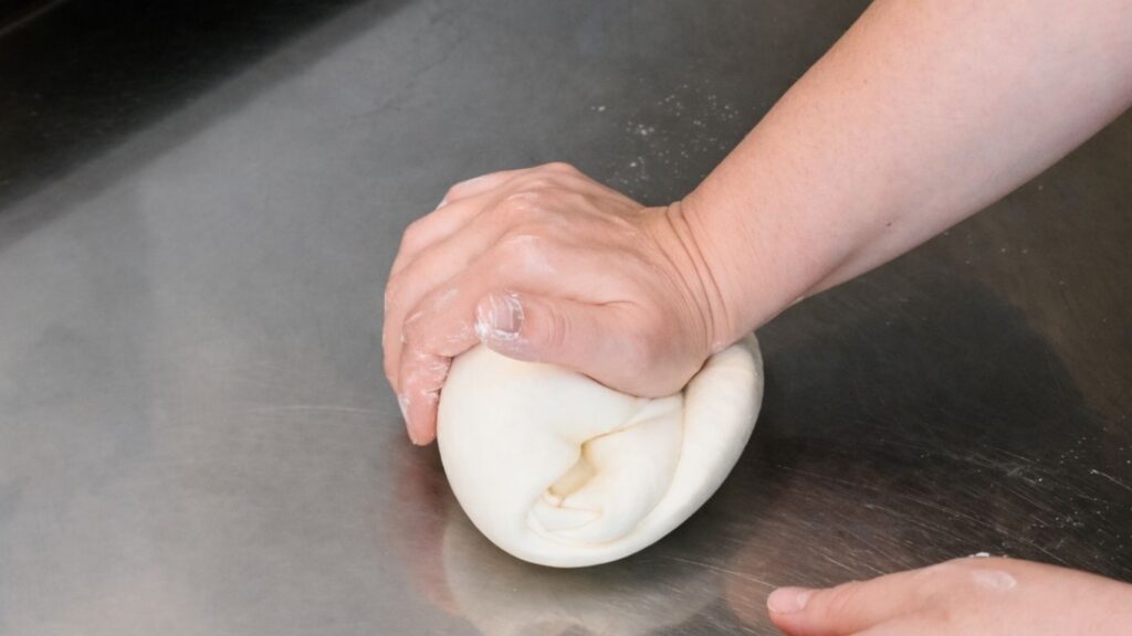 Kneading fondant by hand for a 3-tier wedding cake
