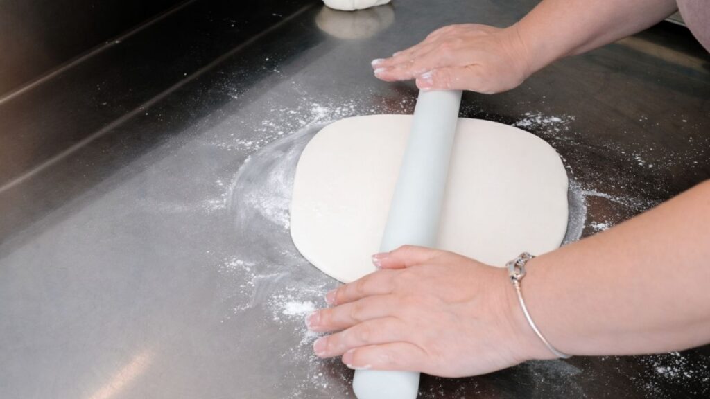 Rolling out fondant for a 3-tier wedding cake