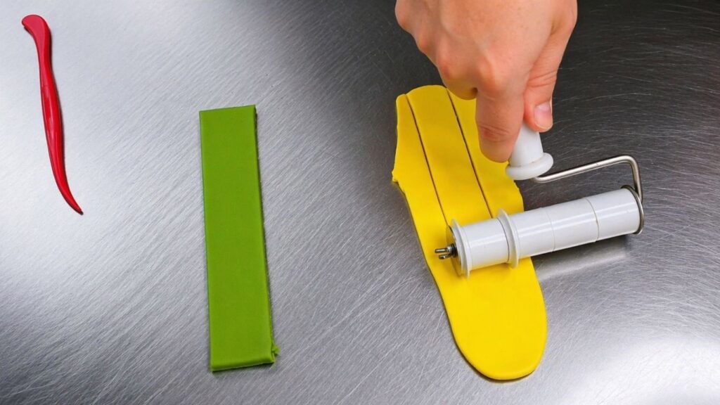 Shaping a fondant bow by folding and pinching strips to decorate the candy cake.