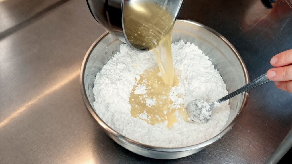 homemade fondant recipe – pouring hot dextrose mixture into powdered sugar