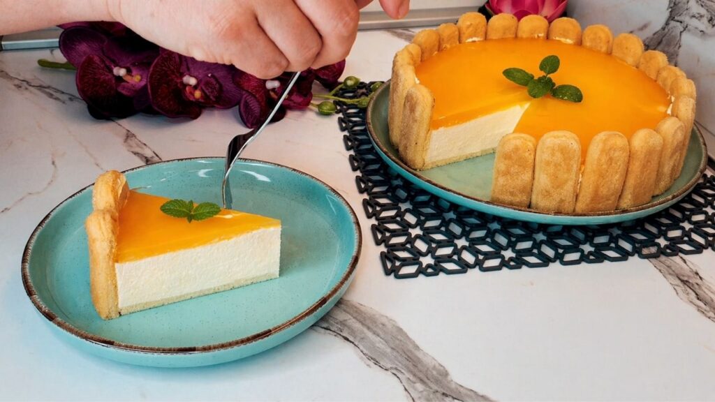 Finished no-bake lemon cake with ladyfingers, glossy lemon glaze, and fresh mint on top