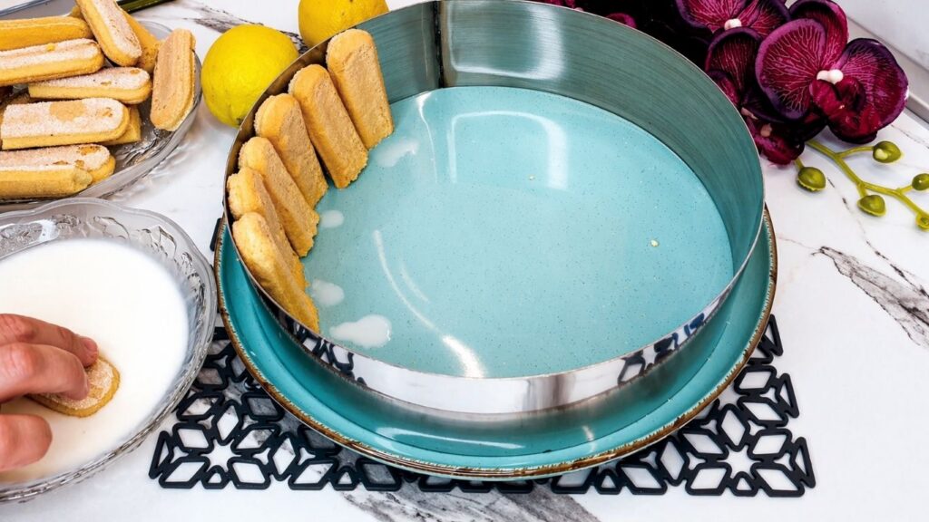 Arranging ladyfingers in the cake pan for no-bake lemon cake